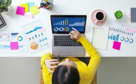 Above top desk of SME owner people home office call talk in SEO chart sale report Above top desk of SME owner people home office call talk in SEO chart sale report